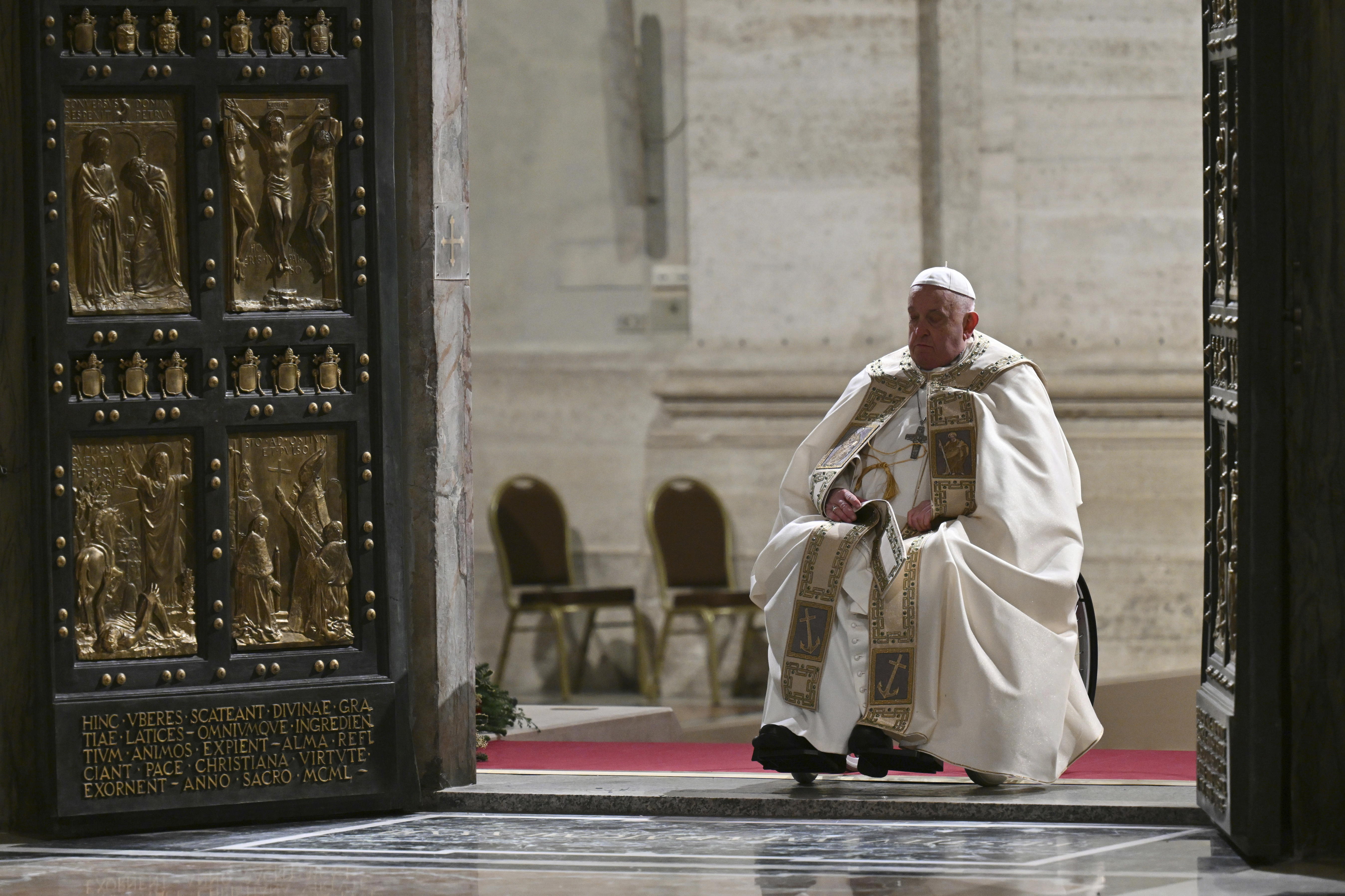 Pope Francis opens the Holy Door of St Peter's Basilica to mark the start of the Catholic Jubilee Year, at the Vatican, Dec. 24, 2024. (Alberto Pizzoli/Pool Photo via AP) 			