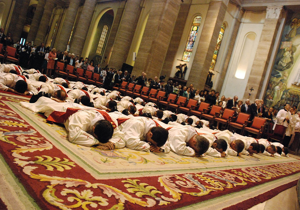 Thirty-eight men lie prostrate during their ordination as priests for Opus Dei at the Basilica of St. Eugene in Rome, in this May 26, 2007, file photo. (CNS/Courtesy of Opus Dei)