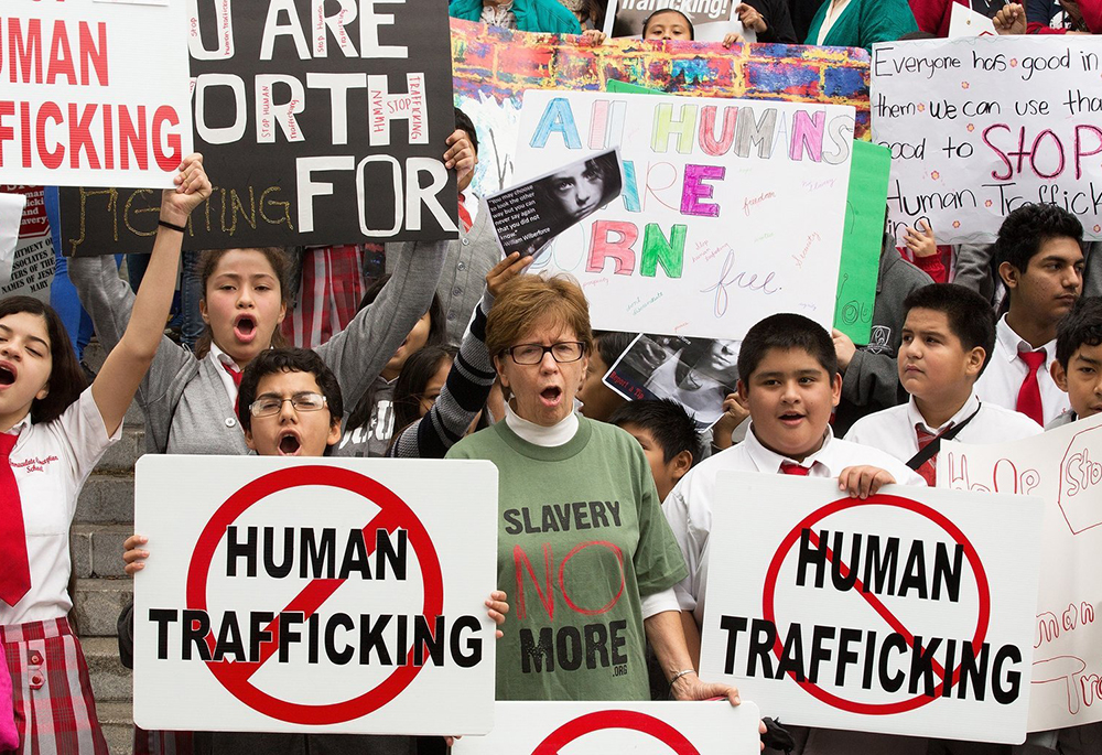 People are pictured in a file photo displaying signs in Los Angeles during the "Walk 4 Freedom" in advance of the Jan. 11, 2024, National Human Trafficking Awareness Day. January is Human Trafficking Awareness month in the U.S. (OSV News/CNS file, Vida Nueva, Victor Aleman)