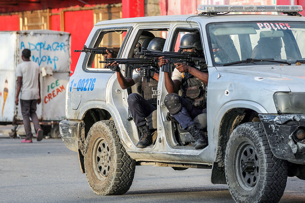 Police officers take part in a confrontation with gangs near the National Palace in Port-au-Prince, Haiti, March 21, 2024. (OSV News/Reuters/Ralph Tedy Erol)