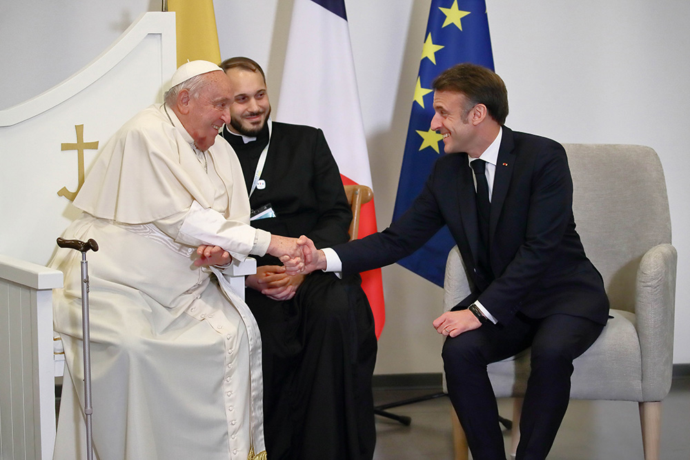 Pope Francis meets with French President Emmanuel Macron at Ajaccio Napoleon Bonaparte Airport during his one-day visit to Ajaccio, France, Dec. 15, 2024. (CNS/Lola Gomez)