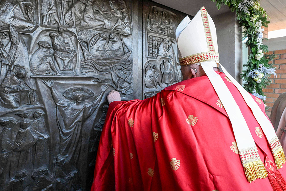 Pope Francis knocks on the Holy Door of the Church of Our Father at Rome's Rebibbia prison Dec. 26, 2024, before opening it and presiding over a Mass with inmates, prison staff and Italian government officials. (CNS/Vatican Media)