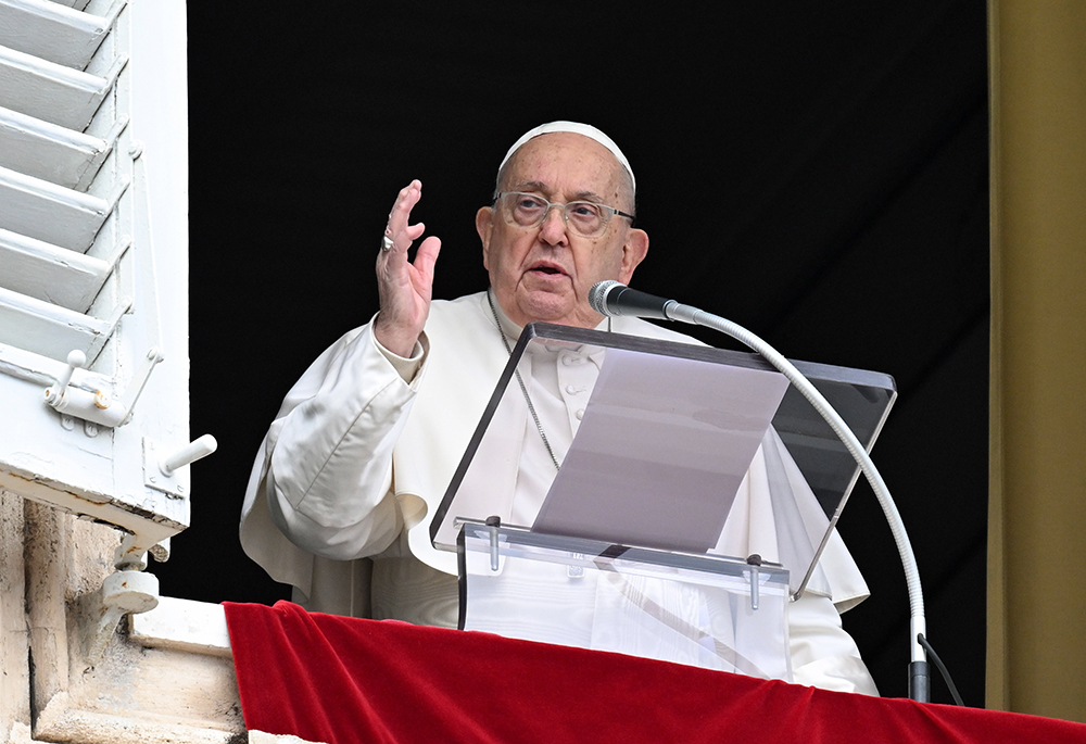 Pope Francis gives his blessing to visitors gathered in St. Peter's Square to pray the Angelus on the feast of the Baptism of the Lord at the Vatican on Jan. 12. (CNS/Vatican Media)