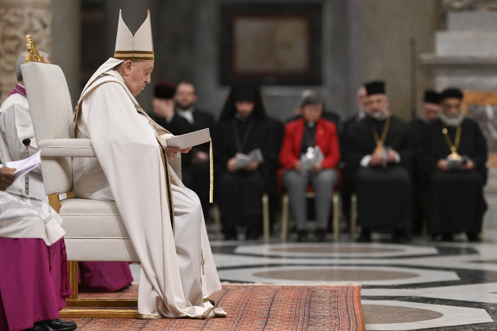 Francis vested and wearing mitre shown in profile sitting on white chair.