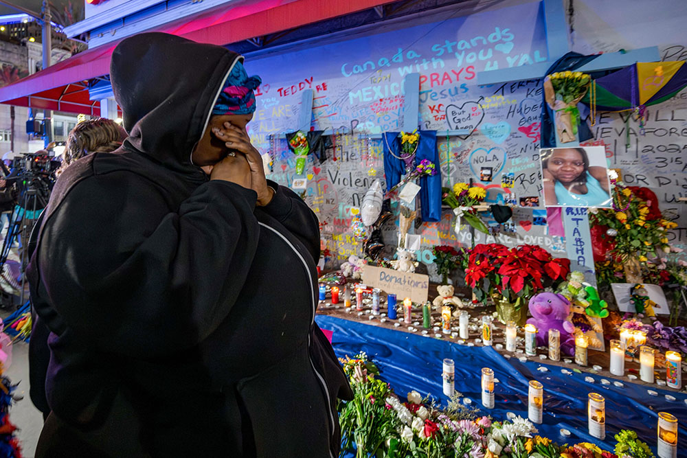 Courtney Polk, cousin of LaTasha Polk, who was killed in the New Year's Day attack, reacts at a memorial on Bourbon Street and Canal Street in New Orleans Jan. 4, 2025, (AP/Matthew Hinton)