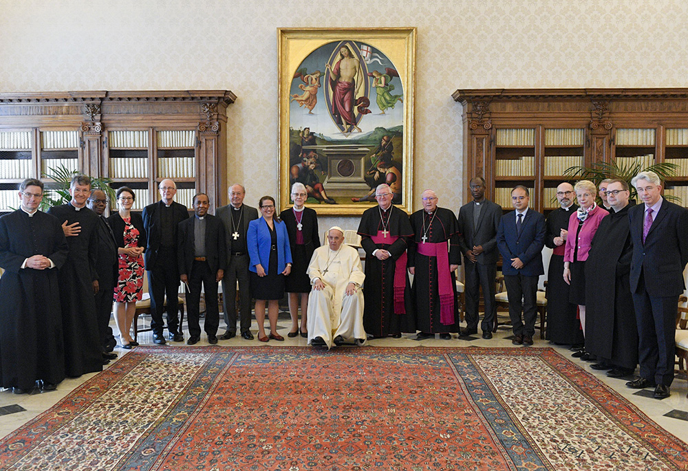 Pope Francis and members of the Anglican-Roman Catholic International Commission pose for a photograph May 13, 2022, in the library of the Apostolic Palace at the Vatican. At the left of the pope is Anglican Archbishop Linda Nicholls, the Anglican primate of Canada and Anglican co-chair of ARCIC; to the right is Archbishop Bernard Longley of Birmingham, the Catholic co-chair of the dialogue. (CNS/Vatican Media)