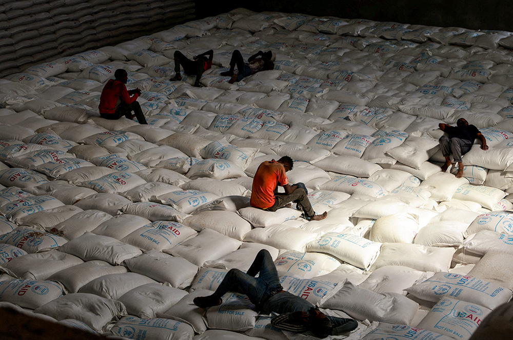 Laborers rest as they offload bags of grains at the World Food Program warehouse in Adama, Ethiopia, Sept. 8, 2022. (CNS/Reuters/Tiksa Negeri)