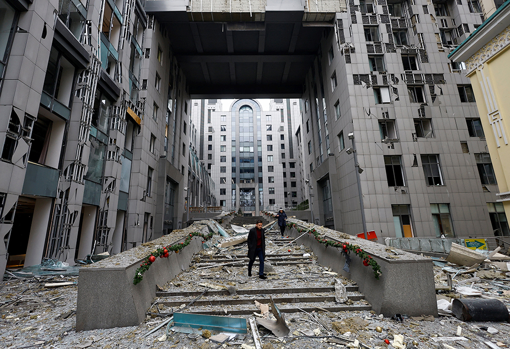 People walk at the site of a Russian missile strike near St. Nicholas Catholic Church on Dec. 20, 2024, in Kyiv, Ukraine, amid Russia's attack on Ukraine. According to the church's rector, Fr. Pavlo Vyshkovsky, cited by the Religious Information Service of Ukraine, the windows in the church's towers were blown out and the stained glass windows were shattered. (OSV News/Reuters/Valentyn Ogirenko)