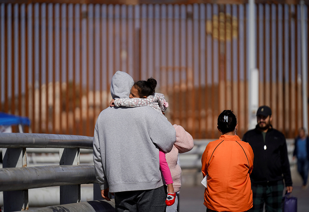 Cuban migrant Marielis Arosh and her family walk with other migrants after their CBP One app asylum appointment was canceled on the day of U.S. President Donald Trump's inauguration, near the border fence Jan. 20 in Mexicali, Mexico. (OSV News/Reuters/Victor Medina)