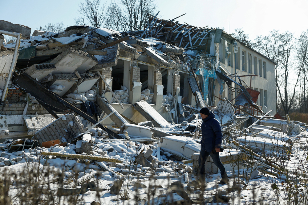 Yurii Bilyk, director of a local lyceum, walks next to the organization's building in Dnipropetrovsk region, Ukraine, Feb. 18, 2025. The structure was destroyed by a recent Russian airstrike.