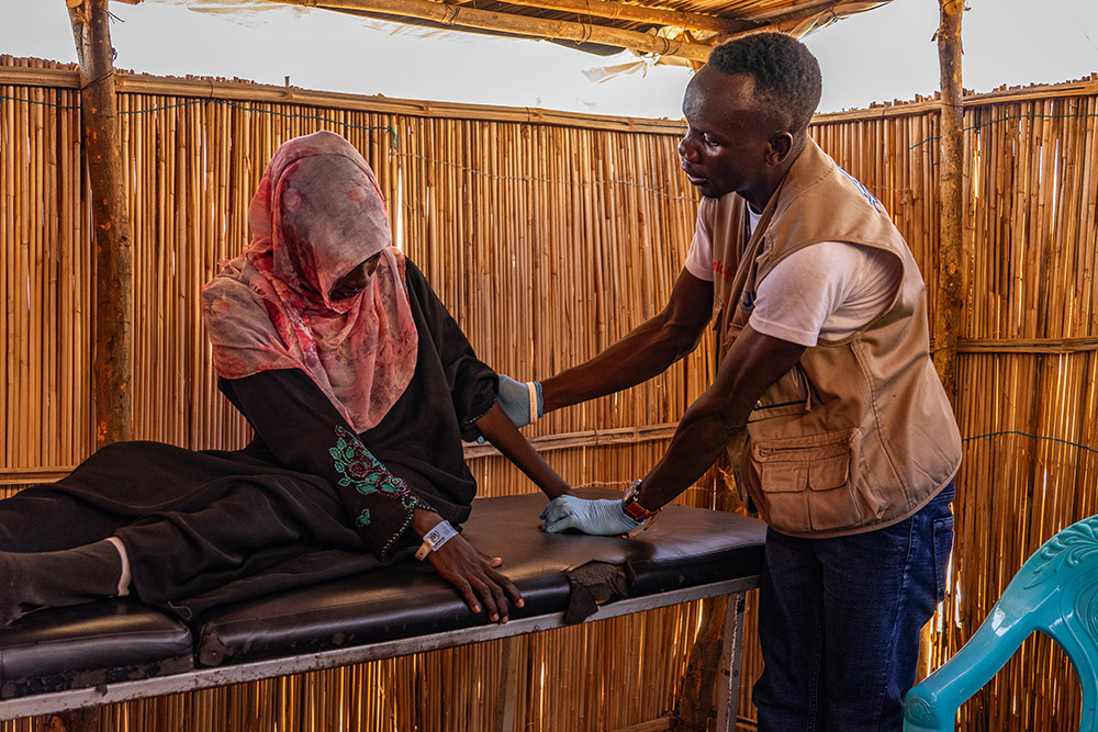 A worker with Jesuit Refugee Service seen in a 2023 photo offers physical therapy to a woman in Renk, South Sudan, as part of the response to the conflict in Sudan. A pause on U.S. foreign aid is affecting critical programs carried out by nongovernmental organizations like JRS. (OSV News/Courtesy JRS)