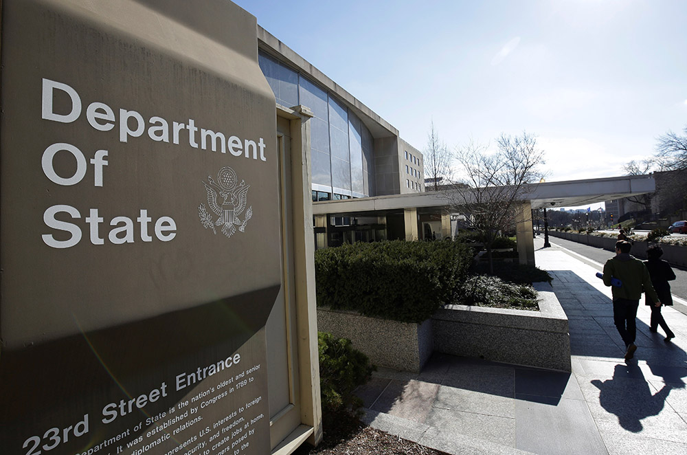 People are pictured in a file photo entering the U.S. Department of State building in Washington. The State Department has terminated its contract with the U.S. Conference of Catholic Bishops to legally resettle refugees, following a suspension of the arrangement in January 2025.(OSV News/Reuters/Joshua Roberts)