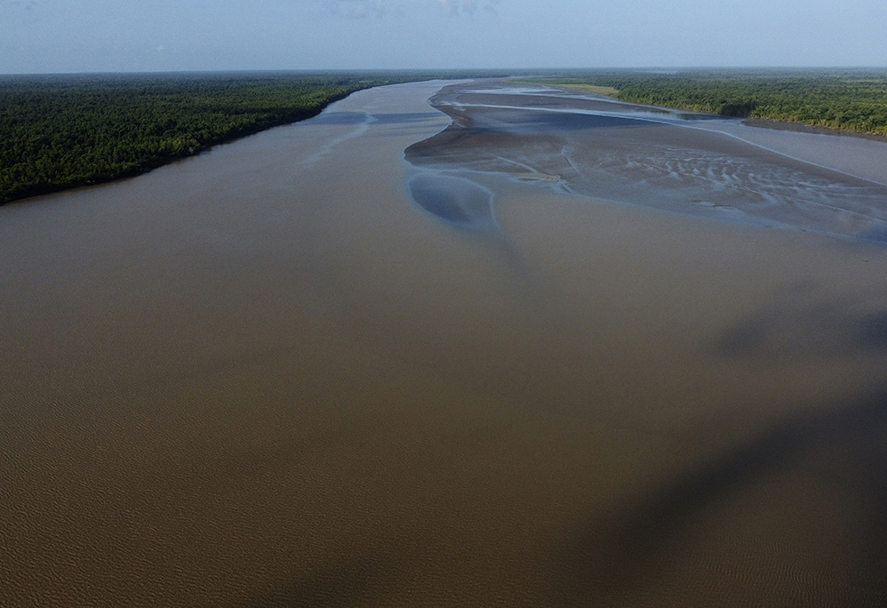 Water flows in at the point where the river meets the sea in the Bailique Archipelago, district of Macapa, state of Amapa, northern Brazil, on Sept. 12, 2022. (AP photo/Eraldo Peres, File)