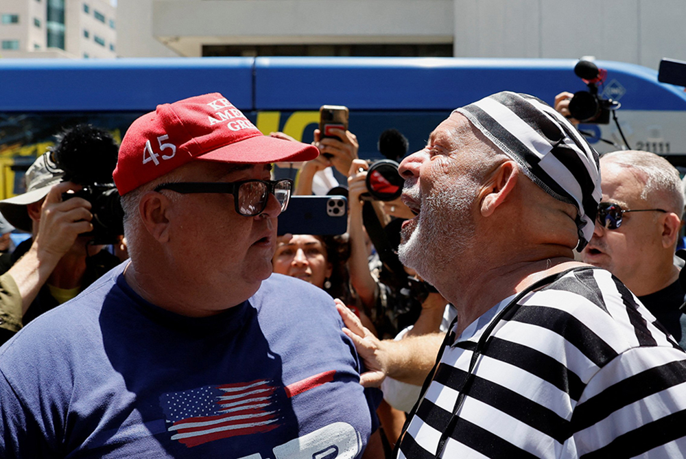 A supporter of then-former U.S. President Donald Trump and an anti-Trump demonstrator argue near the Wilkie D. Ferguson Jr. U.S. Courthouse, on the day Trump appeared for his arraignment on classified document charges, in Miami, Florida, on June 13, 2023. (OSV News/Reuters/Marco Bello)