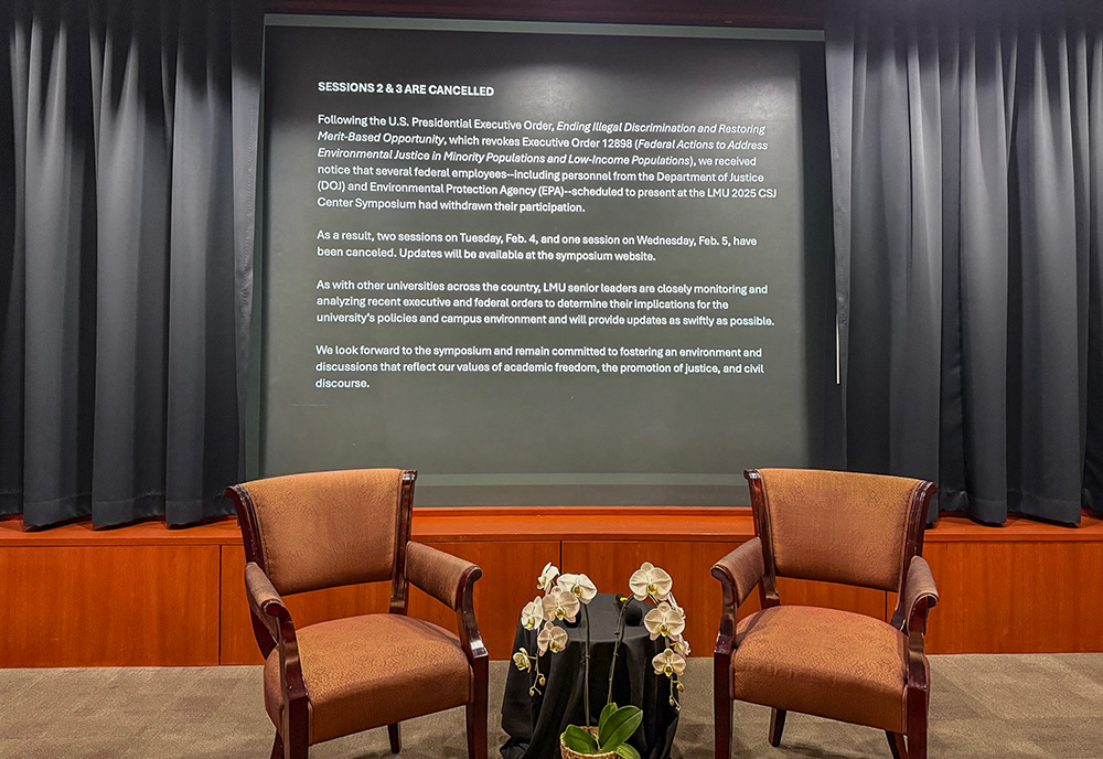 Two empty chairs sit inside Ahmanson Auditorium Feb. 4 at Loyola Marymount University in Los Angeles. Two scheduled conference panels on air quality and environmental justice were canceled after federal workers withdrew from participating due to the Trump administration's directives on diversity programs. (Cecilia González-Andrieu)