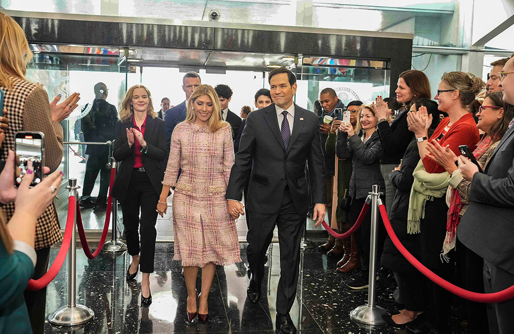 Newly sworn-in Secretary of State Marco Rubio, accompanied by his wife, Jeanette Dousdebes Rubio, is greeted by employees as he arrives at the Department of State in Washington, Jan. 21, 2025. (Wikimedia Commons/U.S. Department of State/Freddie Everett)