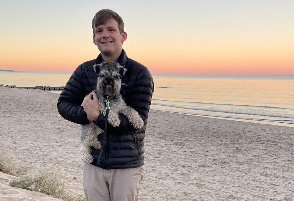 Paul Lucke, a student at St. Thomas University in St. Paul, Minnesota, will lose scholarship money because the Trump administration has canceled a grant to help address teacher shortages. He is pictured with his dog, Charlie. (Courtesy of Paul Lucke)