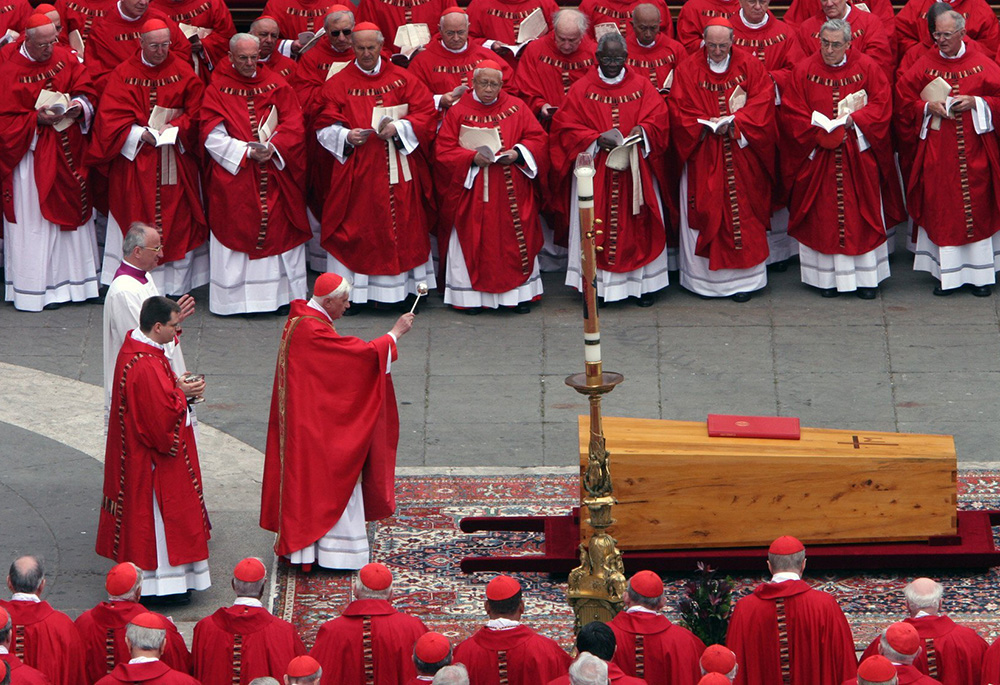 German Cardinal Joseph Ratzinger, the future Pope Benedict XVI, sprinkles holy water on the casket of Pope John Paul II during his funeral Mass in St. Peter's Square at the Vatican in this April 8, 2005, file photo. (OSV News/Catholic Press Photo)