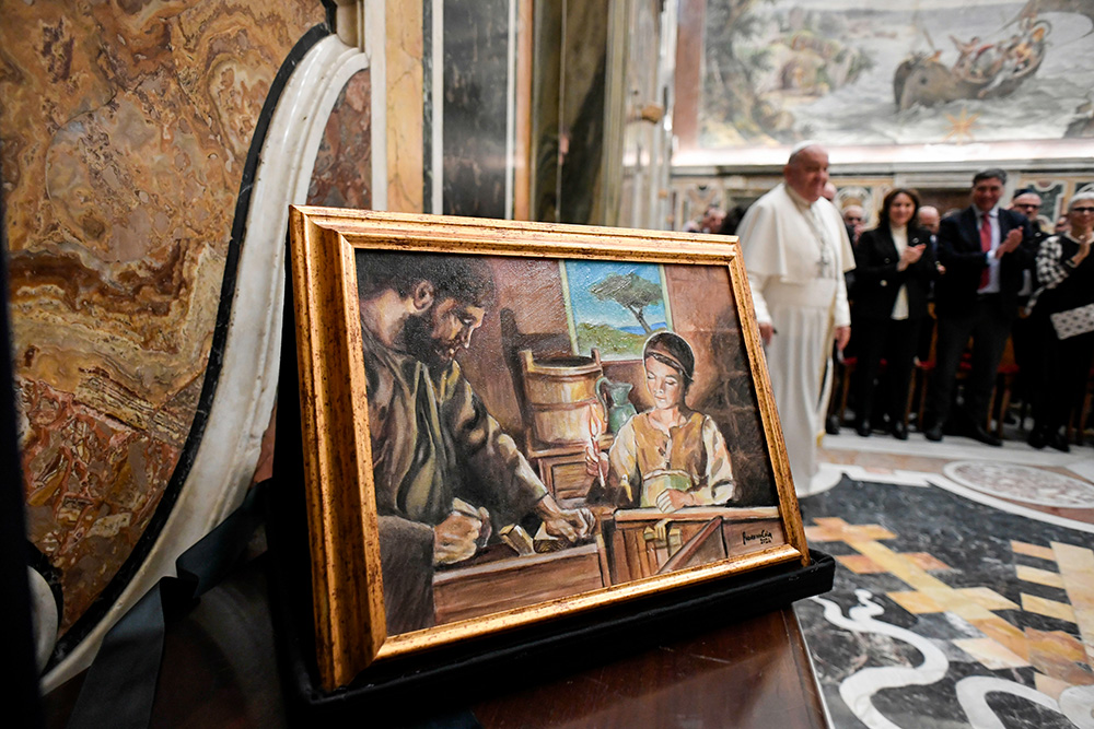 A painting of St. Joseph and Jesus is seen as Pope Francis arrives for an audience at the Vatican with members of Italy's National Confederation of Craft Trades and Small- and Medium-Sized Enterprises Nov. 15, 2024. (CNS/Vatican Media)