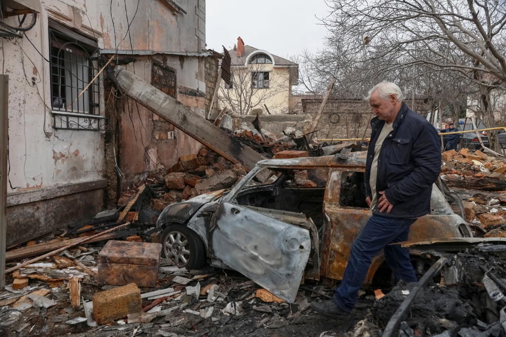 A sad-looking resident is seen walking through rubble at a site of an apartment building in Odesa, Ukraine, which was hit by a Russian drone strike amid Russia's attack on Ukraine.