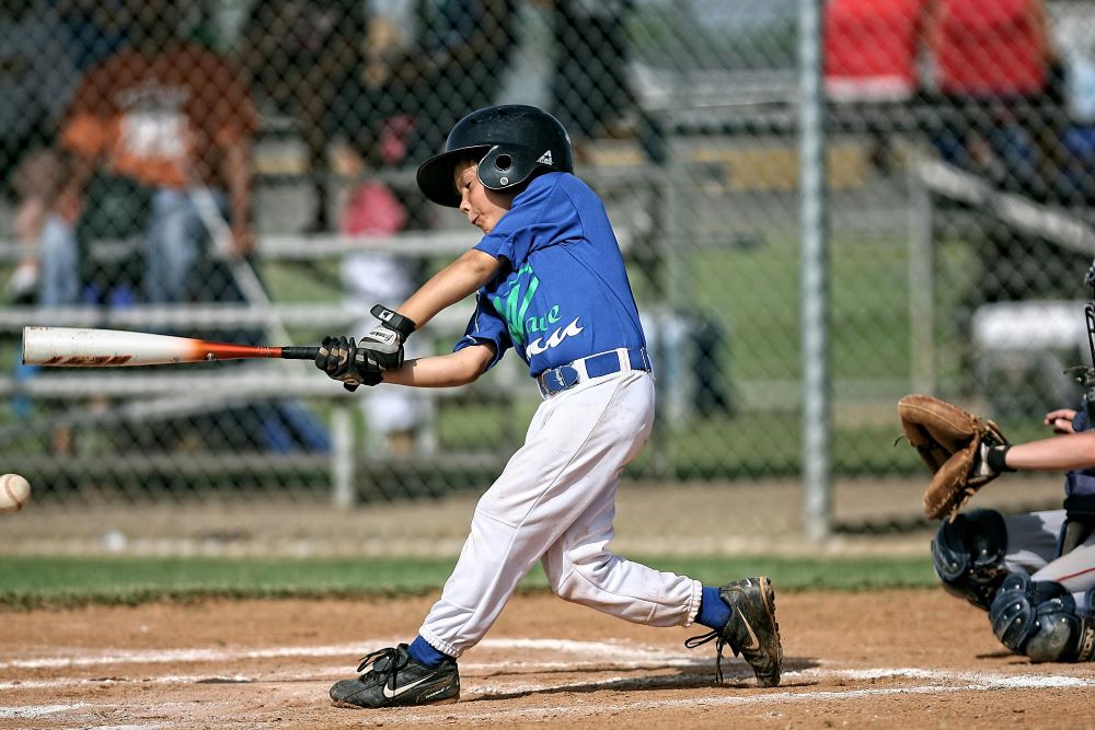 Boy swings baseball bat.