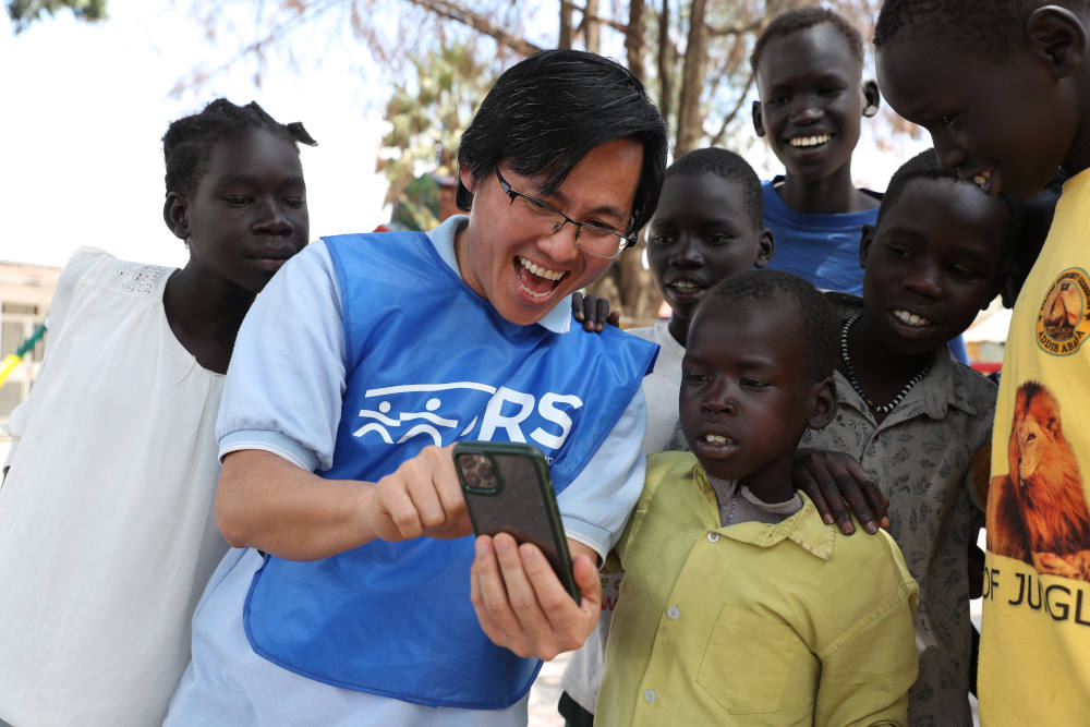 Jesuit Fr. Cao Gia, a member of Jesuit Refugee Service, engages children at the Refugee Community Centre in Addis Ababa, Ethiopia. The U.S. State Department terminated JRS funding for its program in Ethiopia to provide protections and foster care for unaccompanied children. (Francesco Malavolta/Jesuit Refugee Service)