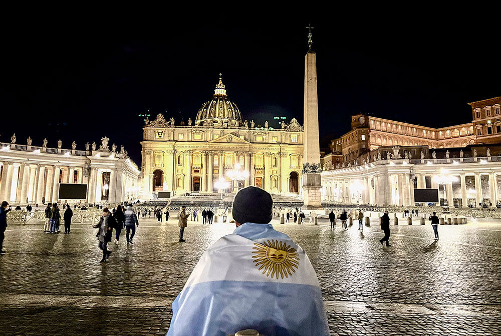 An Argentine Catholic prays for Pope Francis in St. Peter’s Square on the night of Friday, Feb. 28. (NCR photo/Camillo Barone)