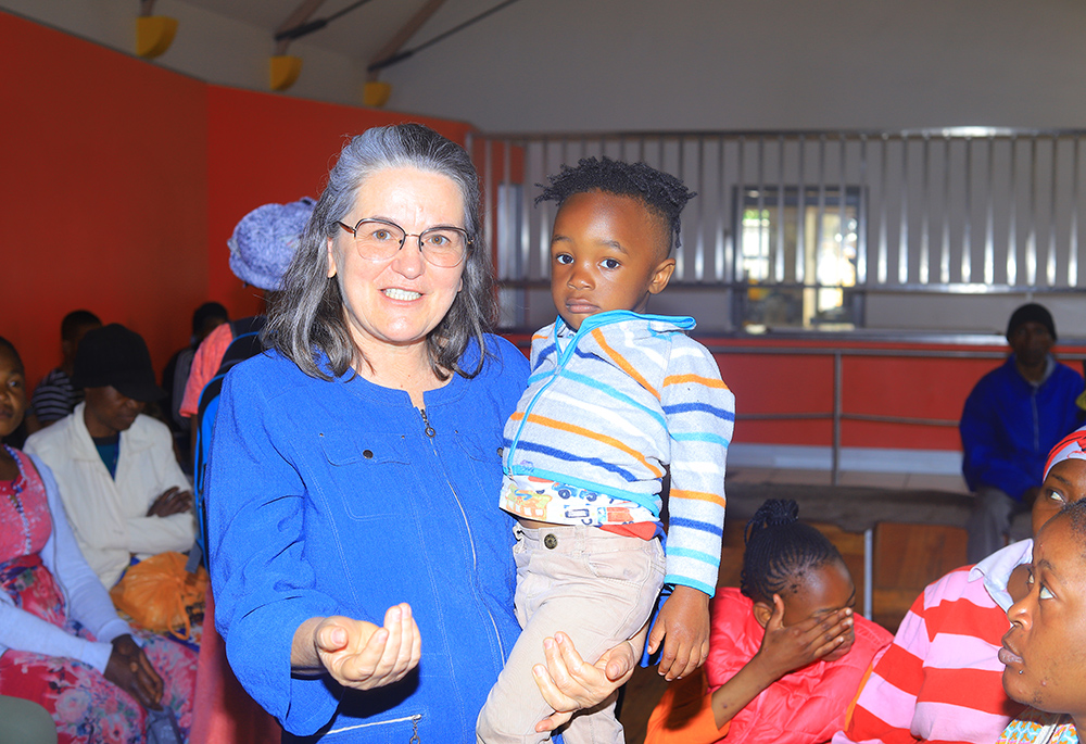 Sr. Marizate Gabin carries a child of a migrant woman at the Office for Pastoral Care of Migrants and Refugees in the Archdiocese of Johannesburg, South Africa. (GSR photo/Doreen Ajiambo)