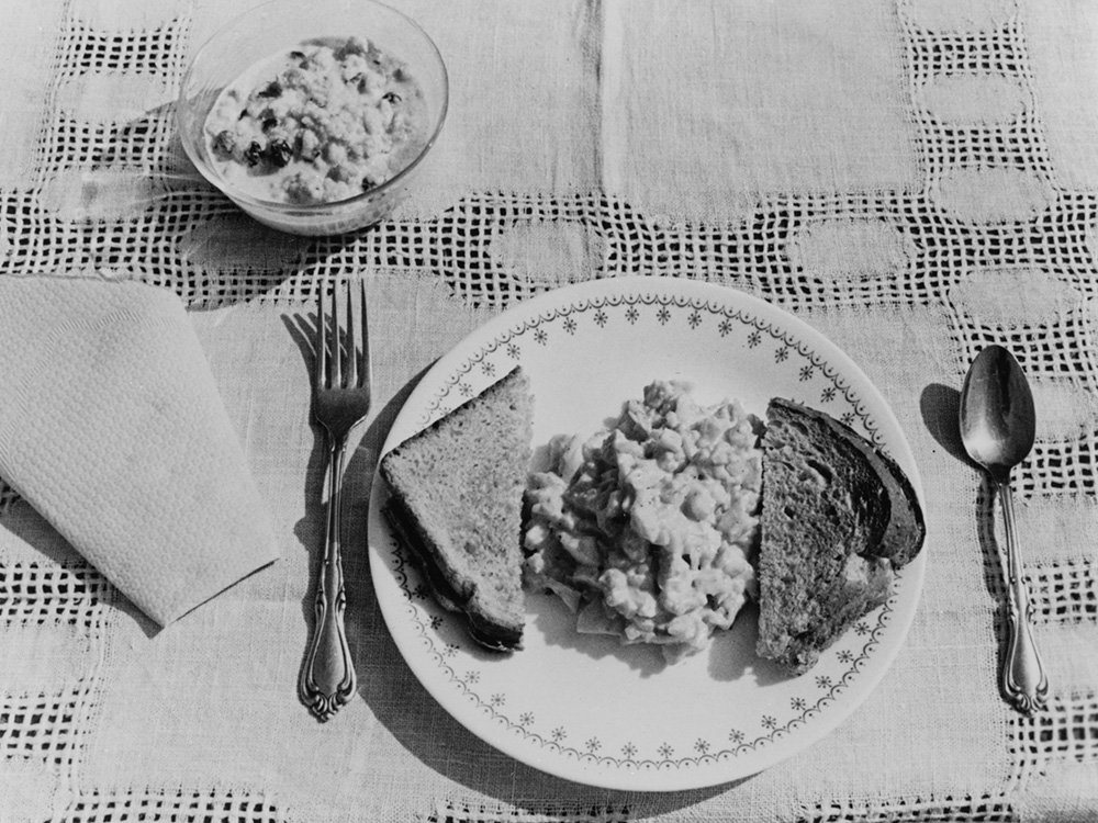 An example for a simple meal for the 1976 Operation Rice Bowl campaign consists of egg salad, toast and rice pudding. (CNS/Robert H. Davis)