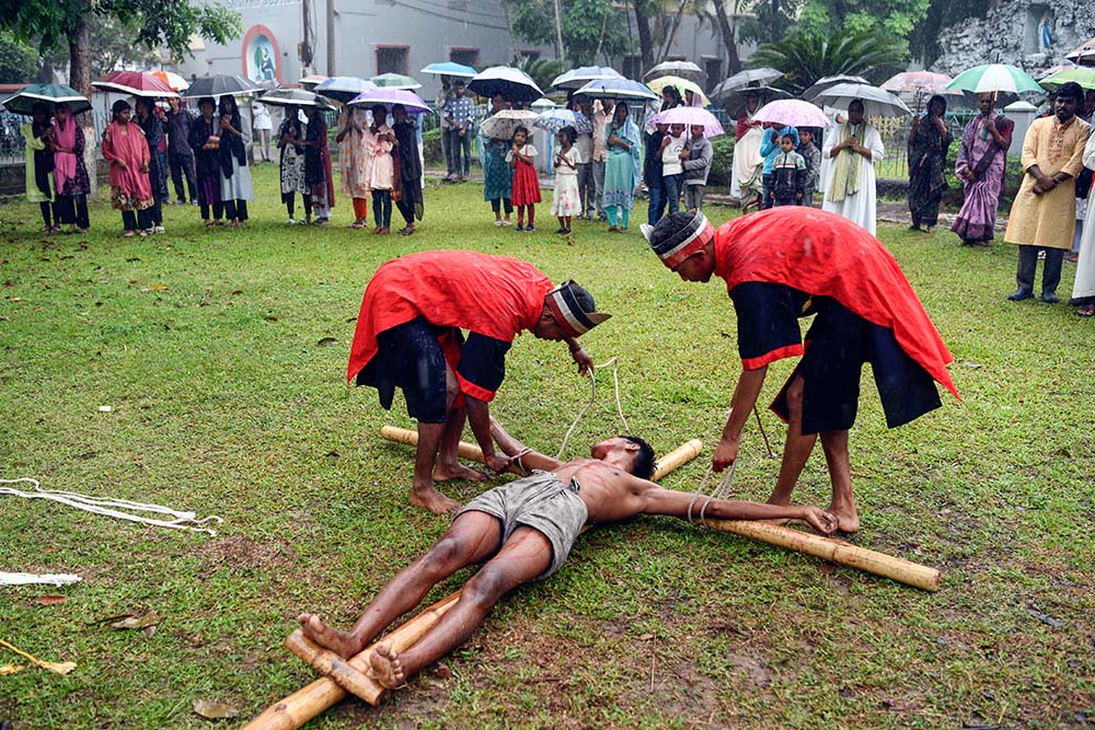 A thief is crucified in front of Dinajpur Cathedral during the Way of the Cross reenactment. (Piyas Biswas)