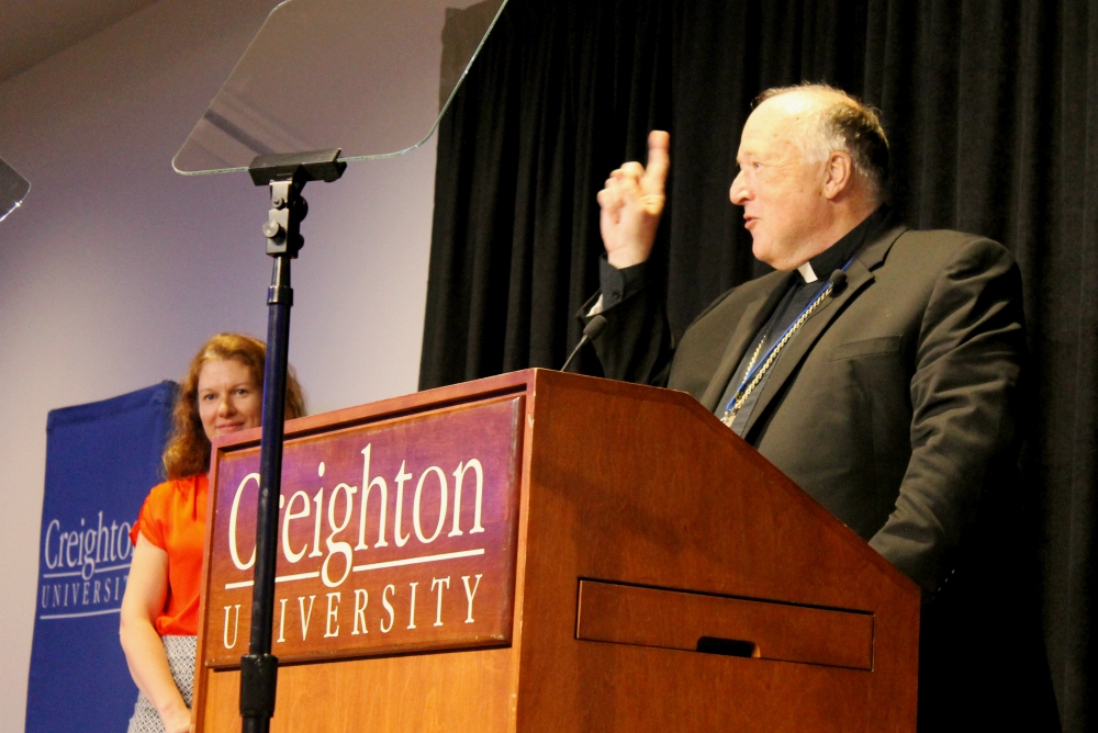 San Diego Bishop Robert McElroy counts down before he leads a sing-along of "God Bless America" during the inaugural "Laudato Si' and the U.S. Catholic Church" conference series June 27 at Creighton University in Omaha, Nebraska. (NCR photo/Brian Roewe)