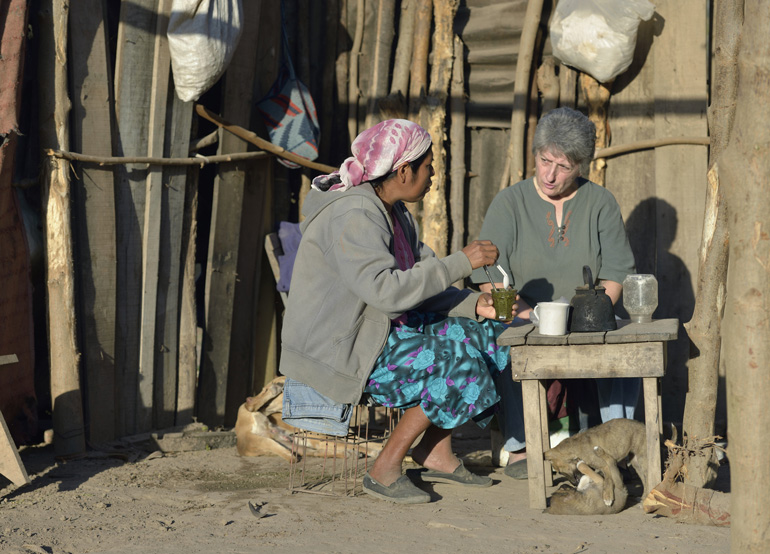 Griselda Arias, a Wichi indigenous woman, shares tea with Sr. Norma Chiappe, a member of the Franciscan Missionaries of Mary, in 2014 at Arias' home in Embarcacion, Argentina.