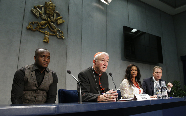 Cardinal Vincent Nichols speaks Oct. 27 at the Vatican Oct. 27. Also pictured: Al Bangura and Princess Inyang, trafficking survivors; far right is Greg Burke (CNS/Paul Haring)