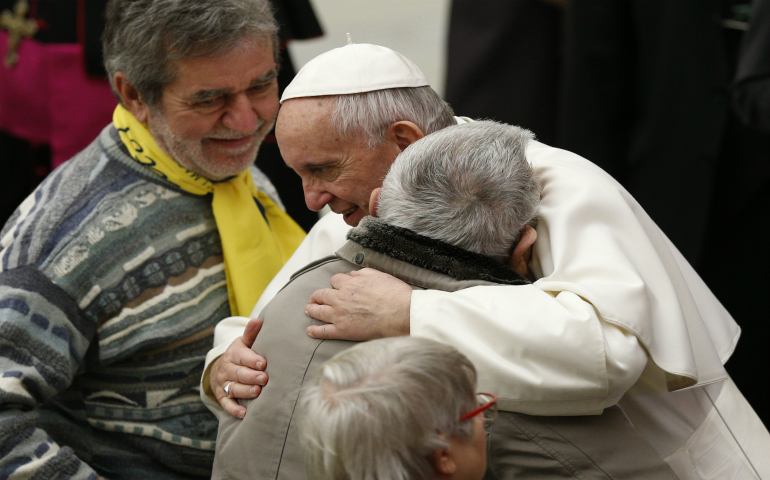 Pope Francis embraces a man while meeting the disabled during his general audience in Paul VI hall at the Vatican Feb. 1. (CNS photo/Paul Haring)