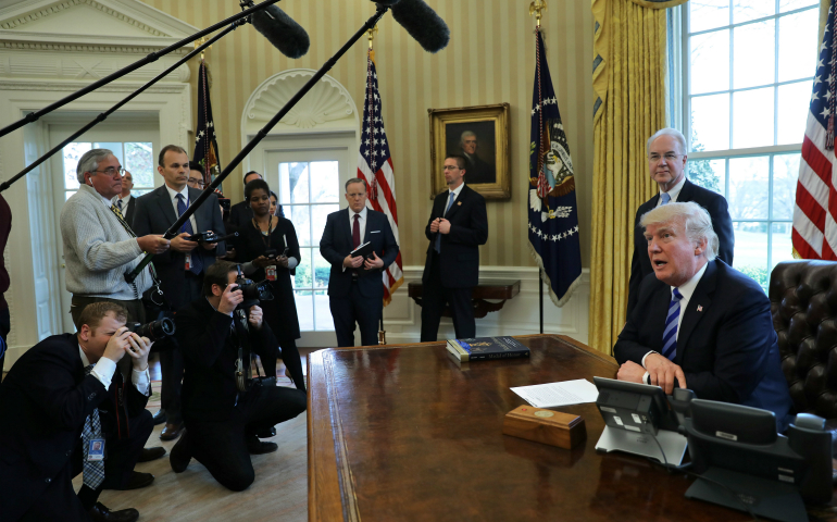 U.S. President Donald Trump talks to journalists in the Oval Office at the White House March 24 after the American Health Care Act was pulled before a vote. (CNS photo/Carlos Barria, Reuters)