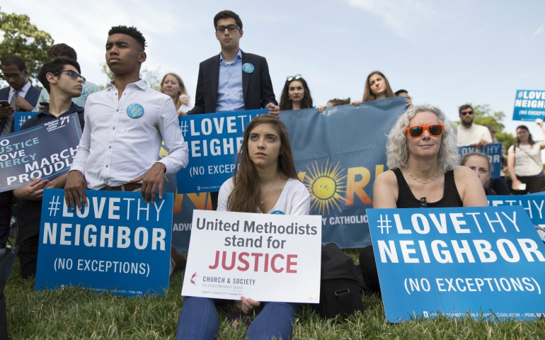 People hold signs during the launch of a 23 hour prayer vigil focused on preserving Medicaid June 29 on Capitol Hill in Washington. (CNS photo/Jaclyn Lippelmann)