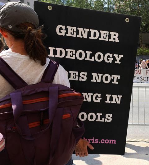 A person protesting medical treatments for youth who identify as transgender stands across the street from counterprotesters outside Children's Hospital Sept. 18, 2022, in Boston. Surgery and medical intervention to change a person's "sex characteristics" to those of opposite sex "are not morally justified," the U.S. bishops' doctrine committee said in a statement issued March 20. (OSV News/Reuters/Brian Snyder)