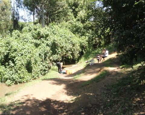 Women wash laundry along the bank of the Kalondon River in Nyeri County, Kenya. The river is threatened by unsustainable use and climate change. (Courtesy of Shadrack Omuka)