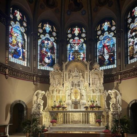 Ornate altar and stained glass windows.