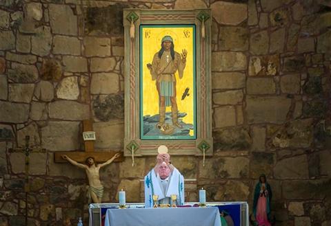 Franciscan Fr. Larry Gosselin celebrates Mass beneath the "Apache Christ" at St. Joseph Apache Mission in Mescalero, New Mexico. Gosselin is a former pastor of St. Joseph. (Courtesy of Dave Mercer)