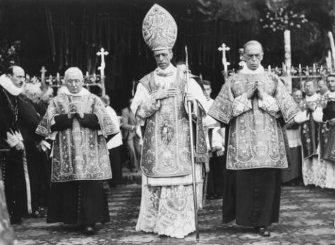 Black and white photo of Pius XII processing in regalia. 