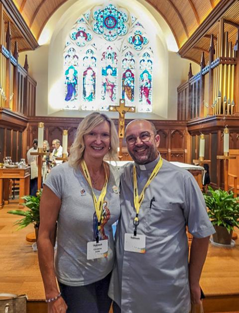 Christine Zuba and Fr. Andrea Conocchia pose for a photo Aug. 3 after Mass during the 2024 Outreach conference. (NCR photo/Camillo Barone)