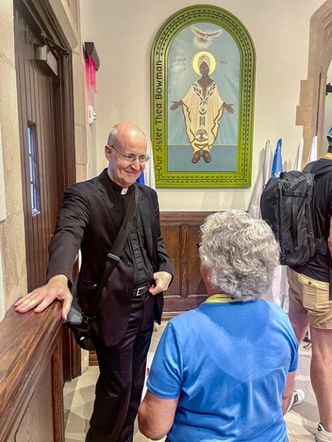 Outreach founder Jesuit Fr. James Martin speaks with an attendee on Aug. 3 during a break at the 2024 conference at Georgetown University. (NCR photo/Camillo Barone)