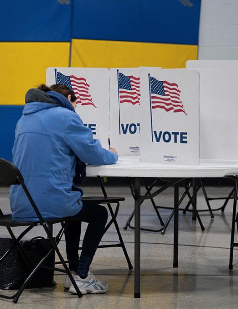 A woman prepares to vote in the presidential primary election at a polling place April 2 in Superior, Wisconsin. (OSV News/Reuters/Erica Dischino)