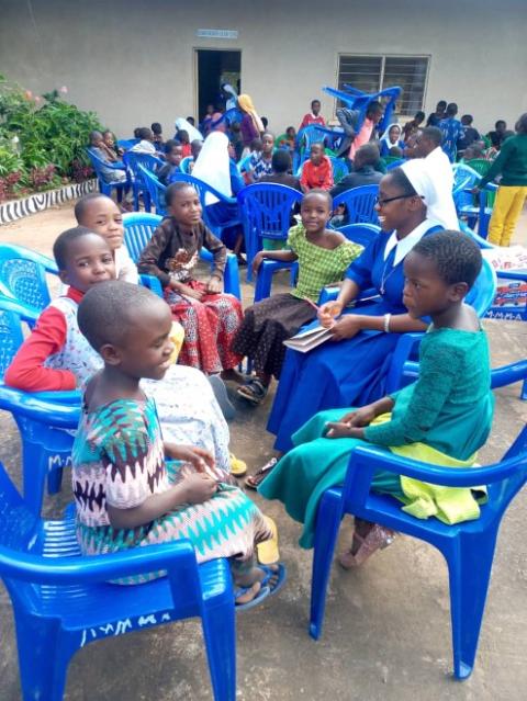 Sr. Anet Pesambili prepares children for their first Communion while educating them about human trafficking. (Courtesy of the Congregation of Our Lady, Queen of Africa)