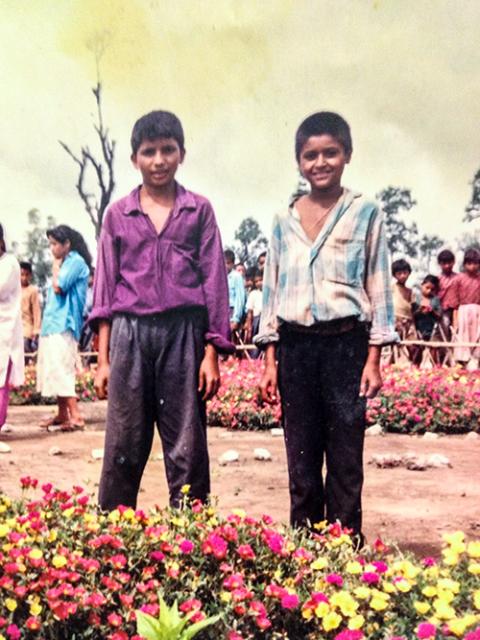 Leela Kuikel (right) with a friend in 1993, in the refugee camp in Nepal where he lived for about 16 years (Courtesy of Leela Kuikel)