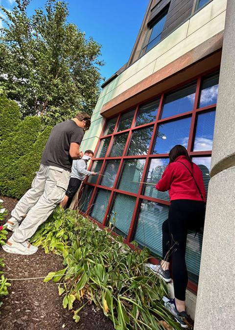 Catholic University of America students take measurements of the pastoral center for the Newark Archdiocese as part of a pilot course providing energy and sustainability recommendations to Catholic dioceses. (Patricia Andrasik)