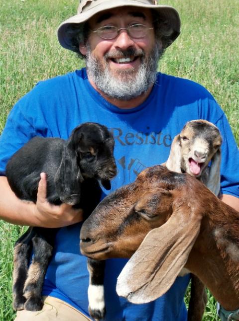 Brian Terrell and goats at Strangers and Guests Catholic Worker Farm in Maloy, Iowa (Betsy Keenan)