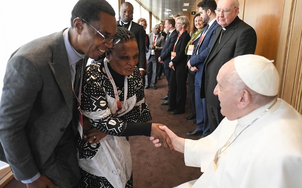 Pope Francis greets participants after speaking at a Vatican conference, "Pastors and lay faithful called to walk together," Feb. 18, 2023, in the Vatican synod hall. The meeting was sponsored by the Dicastery for Laity, the Family and Life. This October's meeting on the future of the church will take place in the larger Pope Paul VI audience hall.  (CNS/Vatican Media)