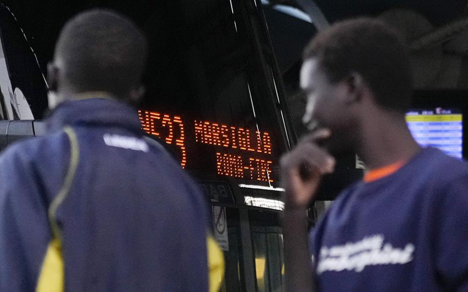 Migrants wait to board a bus headed to Marseille, France, on Sept. 12 in Rome. An appeal to welcome and integrate migrants is expected to be at the top of Pope Francis' agenda as he travels to the French port city Sept. 22-23. (AP Photo/Gregorio Borgia)